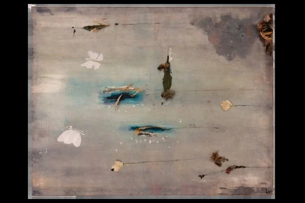 Aerial view of shallow water with scattered boats, debris, and sandy areas in muted gray and blue tones