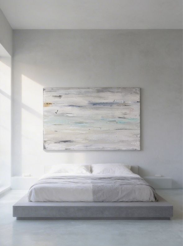 Minimalist white bedroom with low platform bed and abstract striped artwork above headboard
